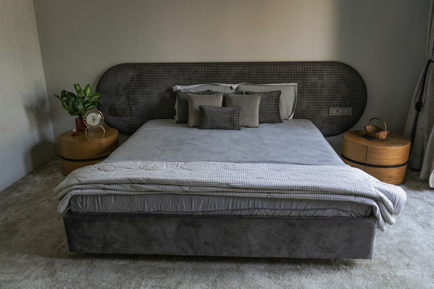 Upholstered bed with layered linens in a contemporary bedroom