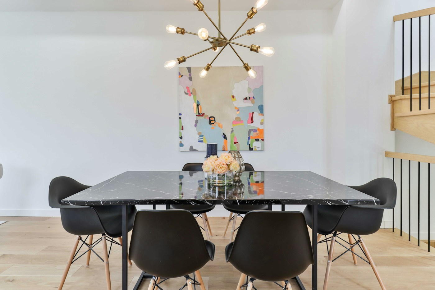 Marble dining table surrounded by black chairs